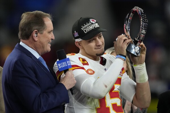 Kansas City Chiefs quarterback Patrick Mahomes (15) holds up the Lamar Hunt Trophy after the AFC Championship NFL football game against the Baltimore Ravens, Sunday, Jan. 28, 2024, in Baltimore. The Chiefs won 17-10. (AP Photo/Nick Wass)
