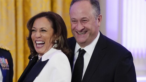 FILE - Vice President Kamala Harris and her husband Doug Emhoff arrive in the East Room of the White House following a dinner reception for the governors and their spouses on Feb. 11, 2023, in Washington. Emhoff met with former New Zealand Prime Minister Jacinda Ardern Friday, July 21, to discuss ways to combat online hate and extremism. (AP Photo/Manuel Balce Ceneta, File)