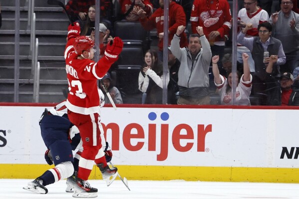 Detroit Red Wings left wing Lucas Raymond (23) celebrates his goal against the Washington Capitals during the first period of an NHL hockey game Tuesday, Feb. 27, 2024, in Detroit. (AP Photo/Duane Burleson)