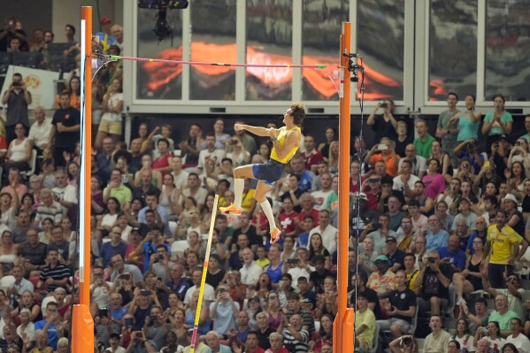 Armand Duplantis, of Sweden, clears a height in the Men's pole vault final during the World Athletics Championships in Budapest, Hungary, Saturday, Aug. 26, 2023. (AP Photo/Martin Meissner)