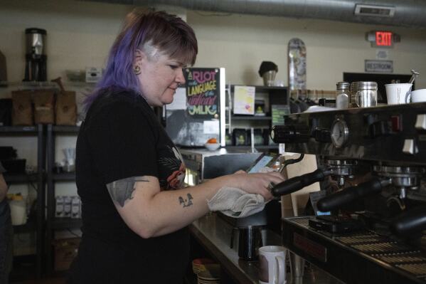 Renee Colon, co-owner of Fuego Coffee Roasters, uses a coffee machine, Saturday, March 22, 2025, in Rochester, N.Y. (Max Conway via AP)