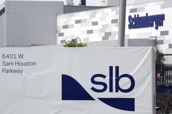 A sign for SLB, formerly Schlumberger, is displayed at the building on Tuesday, March 21, 2023, in Houston. Major American providers, the largest being SLB, of oilfield services supplied Russia with millions of dollars in equipment for months after its invasion of Ukraine, helping to sustain a critical part of its economy even as Western nations launched sanctions aimed at starving the Russian war effort. (AP Photo/David J. Phillip)