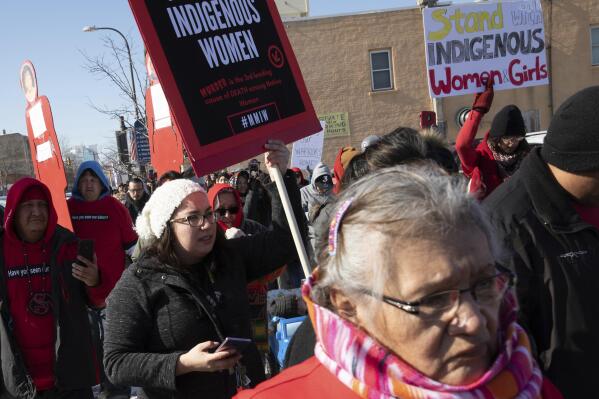 FILE - People participate in a march in downtown Rapid City, S.D., on Feb. 14, 2019, to call attention to missing and murdered Native American women and girls. A federal judge has ruled Tuesday, May 23, 2023, that the U.S. government has a treaty obligation to support law enforcement on the Pine Ridge Reservation in South Dakota, but declined for now to determine whether the Oglala Sioux Tribe is entitled to as much funding as it's seeking and ordered both sides to try to negotiate a resolution. (Ryan Hermens/Rapid City Journal via AP, File)
