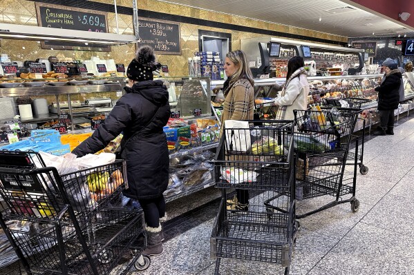 Customers wait for orders at a grocery store in Wheeling, Ill., Friday, Jan. 19, 2024. On Friday, the Commerce Department issues its December report on consumer spending. (AP Photo/Nam Y. Huh)