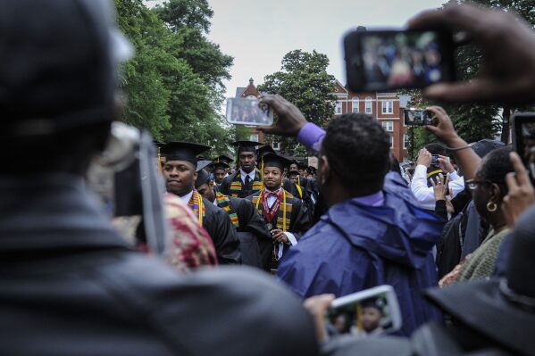 The Morehouse College graduating class makes its way past past camera phones as it arrives for commencement during graduation ceremony held at the campus on May 18, 2014, in Atlanta. (John Amis/Atlanta Journal-Constitution via AP, file)