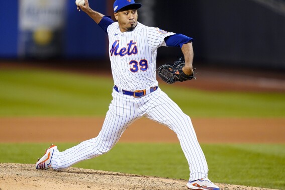 FILE - New York Mets relief pitcher Edwin Díaz delivers against the San Diego Padres during the seventh inning of Game 2 of a National League wild-card baseball playoff series Oct. 8, 2022, in New York. After throwing his first outdoor bullpen session following knee surgery, Mets All-Star closer Díaz remained hopeful he can make return to the mound for the New York Mets this season. (AP Photo/Frank Franklin II, File)