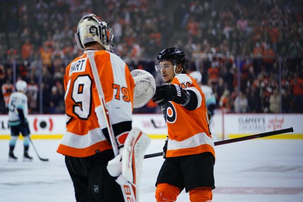 Philadelphia Flyers' Travis Konecny, right, celebrates with Carter Hart after scoring a goal during the first period of an NHL hockey game against the Seattle Kraken, Monday, Oct. 18, 2021, in Philadelphia. (AP Photo/Matt Slocum)