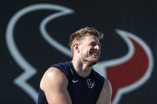 FILE - Houston Texans defensive end J.J. Watt laughs while out on the field with his teammates during an NFL training camp football practice Tuesday, Aug. 25, 2020, in Houston. The Texans could have a good season if Watt stays healthy and tears apart offenses like in his prime. (Brett Coomer/Houston Chronicle via AP, Pool, File)