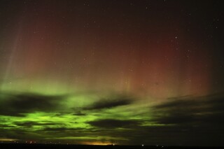 FILE - An aurora borealis, also known as the northern lights, is seen in the night sky in the early morning hours of Monday, April 24, 2023, near Washtucna, Wash. A solar storm forecast for Thursday, July 13, is expected to give skygazers in more than a dozen American states a chance to glimpse the Northern Lights. (AP Photo/Ted S. Warren, File)