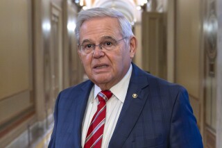 FILE - Sen. Bob Menendez, D-N.J., departs the Senate floor in the Capitol, Sept. 28, 2023, in Washington. Menendez introduced a member of the Qatari royal family and principal in a company with ties to the government of Qatar to a New Jersey businessman before the company invested millions of dollars in the businessman's real estate project, a rewritten indictment alleged Tuesday, Jan. 2, 2024. (AP Photo/Alex Brandon, File)