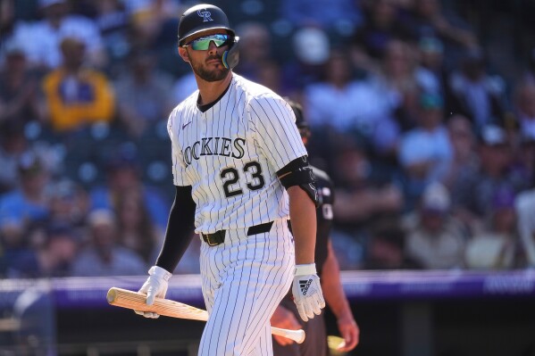 Colorado Rockies's Kris Bryant walks back to the dugout after batting in the eighth inning of a baseball game Thursday, April 10, 2025, in Denver. (AP Photo/David Zalubowski, File)