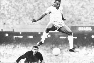FILE - Brazil's Pele scores past Venezuela's goal keeper Fabrizio Fasano in Rio de Janeiro, Brazil, Aug. 24, 1969. Pelé, the Brazilian king of soccer who won a record three World Cups and became one of the most commanding sports figures of the last century, died in Sao Paulo on Thursday, Dec. 29, 2022. He was 82. (AP Photo, File)