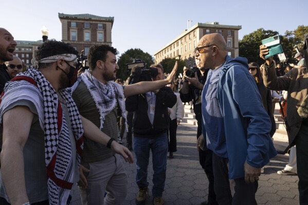 Pro-Palestinian demonstrator Mahmoud Khalil, second from left, debates with a pro-Israel demonstrator during a protest at Columbia University, Thursday, Oct. 12, 2023, in New York. (AP Photo/Yuki Iwamura, File)