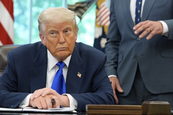 President Donald Trump listens as Health and Human Services Secretary Robert F. Kennedy Jr. speaks as he signs executive orders and proclamations in the Oval Office of the White House, Monday, May 5, 2025, in Washington. (AP Photo/Alex Brandon)