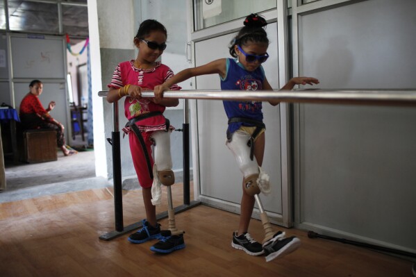 Kendo Taman and Nirmala Pariyar on the left will be trying their first prosthetic legs at a rehabilitation centre in Kathmandu, Nepal on August 19, 2015.
