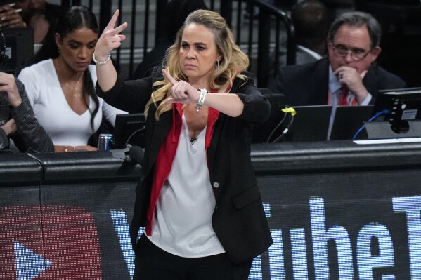 Las Vegas Aces head coach Becky Hammon gestures to her team during the first half in Game 4 of a WNBA basketball final playoff series against the New York Liberty, Wednesday, Oct. 18, 2023, in New York. (AP Photo/Frank Franklin II)