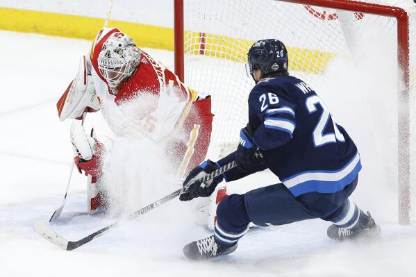 Winnipeg Jets' Blake Wheeler (26) can't get the puck past Calgary Flames goaltender Jacob Markstrom during the first period of an NHL hockey game Wednesday, April 5, 2023, in Winnipeg, Manitoba. (John Woods/The Canadian Press via AP)