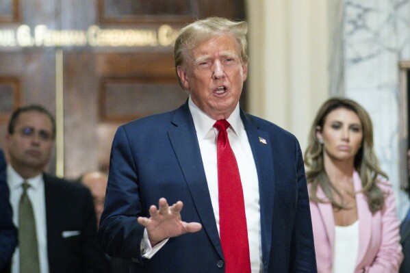 FILE - Former President Donald Trump speaks after exiting the courtroom for a break at New York Supreme Court, Dec. 7, 2023, in New York. New York State Lawyers urged an appeals court Wednesday, March 20, 2024, not to buy Trump's claims that he cannot find a way to post a bond fully covering a $454 million civil fraud judgment while he appeals. (AP Photo/Eduardo Munoz Alvarez, File)