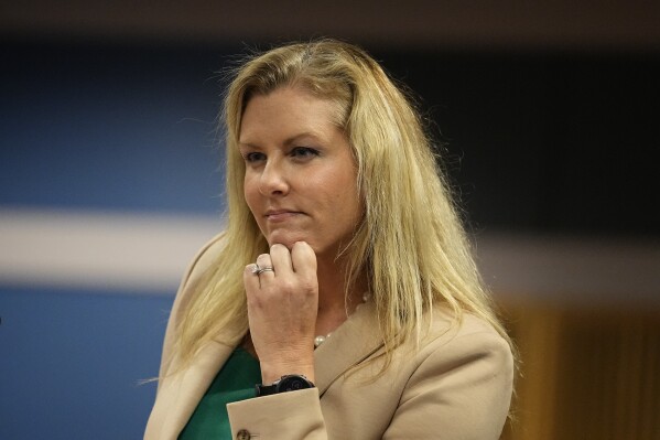 FILE - Attorney Ashleigh Merchant looks on in court, Feb. 27, 2024, in Atlanta. Text messages obtained by The Associated Press show that a former law partner of a special prosecutor in the Georgia election case against Donald Trump was sharing information with the defense attorney of one of Trump’s co-defendants. The attorney, Terrence Bradley, fed Merchant information over a period of several months, making suggestions to help her prove that special prosecutor Nathan Wade was involved in a relationship with Fulton District Attorney Fani Willis. (AP Photo/Brynn Anderson, Pool)
