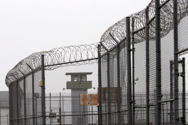 A guard tower and barbed wire fencing stand outside Sing Sing, Sunday, Feb. 16, 2020 in Ossining, N.Y. (AP Photo/Mark Lennihan, File)