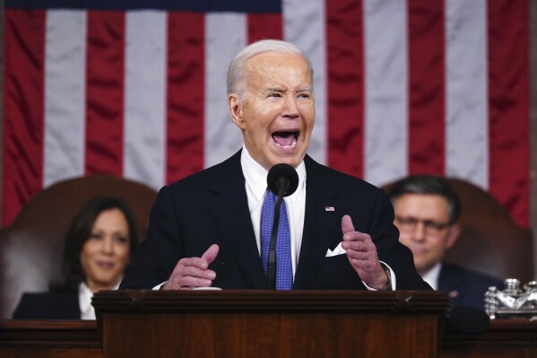 President Joe Biden delivers the State of the Union address to a joint session of Congress at the Capitol, Thursday, March 7, 2024, in Washington. Seated at left is Vice President Kamala Harris and at right is House Speaker Mike Johnson, R-La. (Shawn Thew/Pool via AP)