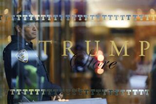 A member of the NYPD stands inside of Trump Tower on Wednesday, March 22, 2023, in New York. As a Manhattan grand jury weighs whether to indict former President Donald Trump over hush money payments made on his behalf during his 2016 presidential campaign, social media users are spreading inaccurate comparisons of Trump’s case and one involving former President Bill Clinton in 1998. (AP Photo/Bryan Woolston)