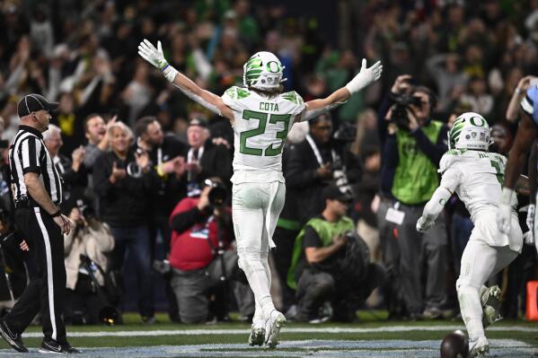 Oregon wide receiver Chase Cota (23) celebrates after scoring a touchdown against North Carolina during the second half of the Holiday Bowl NCAA college football game Wednesday, Dec. 28, 2022, in San Diego. (AP Photo/Denis Poroy)