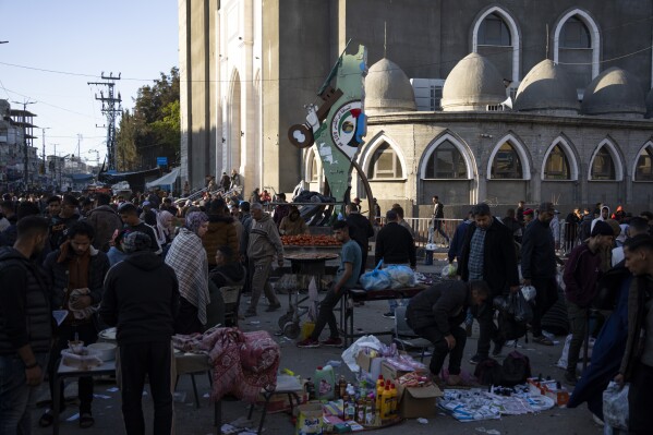 Palestinians crowd at a street market in Rafah, Gaza Strip, Wednesday, Feb. 21, 2024. An estimated 1.5 million Palestinians displaced by the war took refuge in Rafahor, which is likely Israel's next focus in its war against Hamas.(AP Photo/Fatima Shbair)