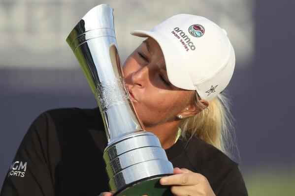 Sweden's Anna Nordqvist kisses the trophy as she poses for the media after winning the Women's British Open golf championship, in Carnoustie, Scotland, Sunday, Aug. 22, 2021. (AP Photo/Scott Heppell)