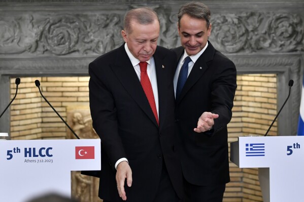 FILE - In this Thursday, Dec. 7, 2023, file photo, Greece's Prime Minister Kyriakos Mitsotakis, right, and Turkey's President Recep Tayyip Erdogan leave after their statements at Maximos Mansion in Athens, Greece. Delegations from Greece and Turkey were meeting in Athens, on Monday, April 22, 2024 as part of long-standing efforts to improve often tense relations between the two neighbors, days after Turkey voiced objections over Greece's plans to create marine nature reserves in the Ionian and Aegean seas. (AP Photo/Michael Varaklas, File)