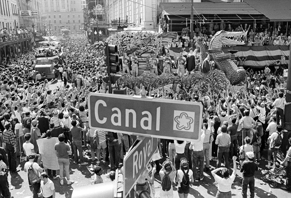 A crowed gathers as floats make their way through Canal Street during the Mardi Gras celebration Feb. 23, 1982, New Orleans, La. (AP Photo Jack Thornell, file)