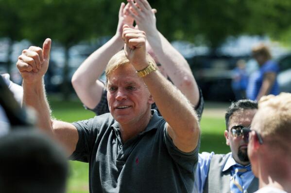 FILE - In an Aug. 12, 2017, file photo, David Duke arrives to give remarks after a white nationalist protest was declared an unlawful assembly, in Charlottesville, Va. Duke, a former Ku Klux Klan leader, has agreed to pay Bill Burke, of Athens, Ohio, $5,000 to settle allegations that Burke was severely injured during a white supremacist and neo-Nazi rally two years ago in Virginia attended by Duke, according to attorneys and court documents. (Shaban Athuman/Richmond Times-Dispatch via AP, File)