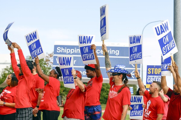 UAW members cheer as employees walkout from the Fort Worth Parts Distribution Center on Friday, Sept. 22, 2023, in Roanoke, Texas. (Shafkat Anowar/The Dallas Morning News via AP)