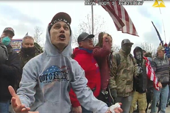 This image from video from a police-worn body camera provided by Justice Department and contained in the government sentencing memorandum shows Frank Rocco Giustino, left, at the Jan. 6, 2021, riot at the U.S. Capitol in Washington. Giustino was sentenced to three months in jail on Nov. 21, 2023. (Justice Department via AP)