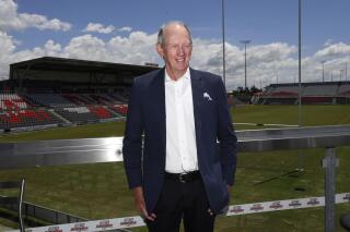 Wayne Bennett, Australia's most successful rugby league coach, poses for a photo in Brisbane's suburb of Redcliffe, Thursday, Oct. 21, 2021. Bennett will be taking over the National Rugby League's newest team after he agreed to lead the Redcliffe-based Dolphins into the top tier in 2023. (Darren England/AAP Image via AP)