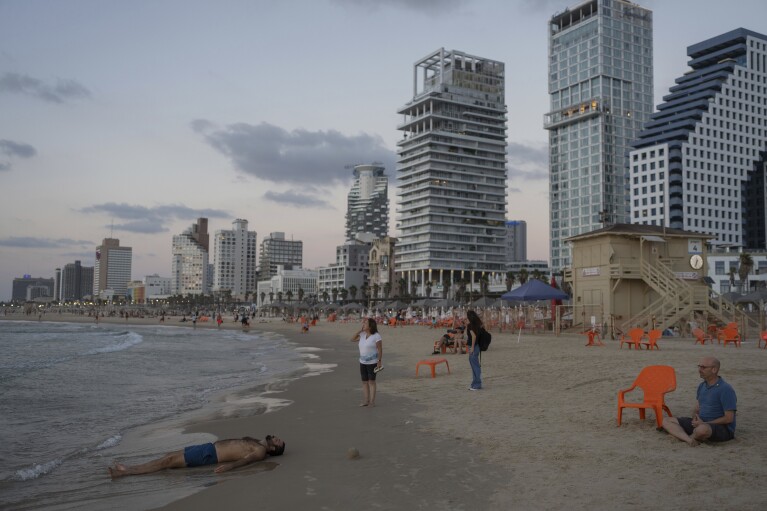 FILE - People at the beach in Tel Aviv, Israel, on Sept. 25, 2024. (AP Photo/Ohad Zwigenberg, File)