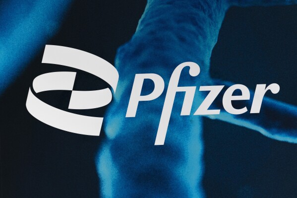 FILE - The Pfizer logo is displayed at the company's headquarters, Friday, Feb. 5, 2021, in New York. Shares of Pfizer are falling before the market opened on Monday, Oct. 16, 2023, as the company cut its full-year outlook, citing declining sales of its COVID-19-related products.(AP Photo/Mark Lennihan)