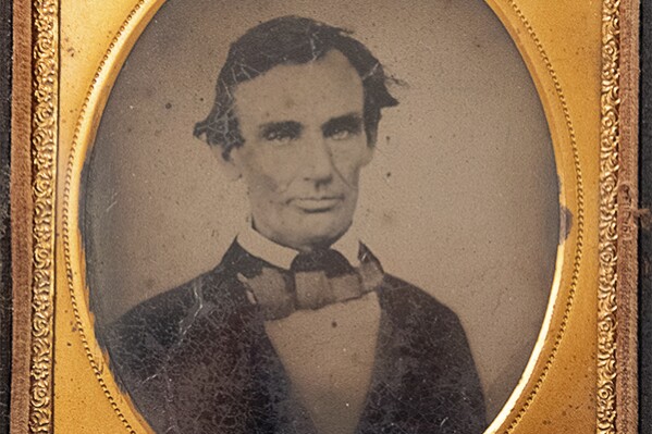 This photo provided by the Abraham Lincoln Presidential Library and Museum shows an ambrotype image of President Abraham Lincoln circa 1858. During his U.S. Senate campaign against Stephen A. Douglas, Lincoln sat for a photograph after politicking in western Illinois and presented one of the copies to a man severely injured while testing a campaign-rally cannon whose life was spared by flesh-eating maggots. That is the unlikely, ghastly background of this original 1858 ambrotype of the future nation-saving Civil War president which the Abraham Lincoln Presidential Library and Museum has added to its collection, officials said Monday, Sept. 25, 2023. (Abraham Lincoln Presidential Library and Museum via AP)