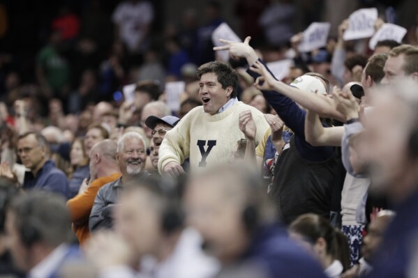 A Yale fan, cdnter, cheers during the second half of a first-round college basketball game against Auburn in the NCAA Tournament in Spokane, Wash., Friday, March 22, 2024. (AP Photo/Young Kwak)