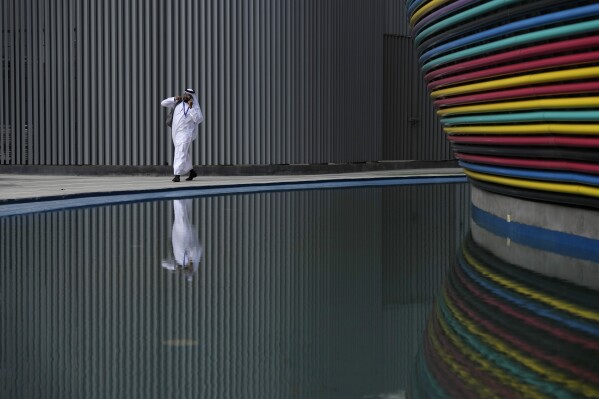 A man walks through the venue for the COP28 U.N. Climate Summit, Nov. 30, 2023, in Dubai, United Arab Emirates. (AP Photo/Peter Dejong)