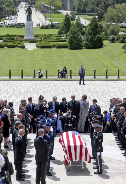 As politicians, dignitaries and former colleagues line the front steps, the casket is brought into the Louisiana State Capital building during an honor procession for former Louisiana Gov. Kathleen Babineaux Blanco, in Baton Rouge, La., Thursday, Aug. 22, 2019. Thursday was the first of three days of public events to honor Blanco, the state's first female governor who died after a years long struggle with cancer. (AP Photo/Michael Democker, Pool)