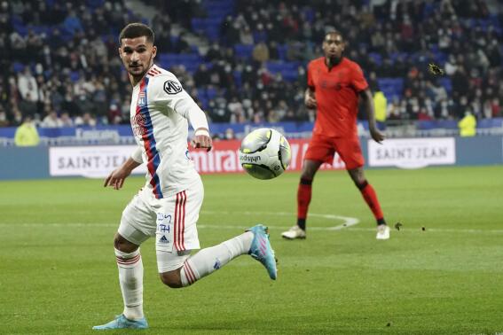 Lyon's Houssem Aouar eyes the ball during the French League 1 soccer match between Lyon and Nice, at the Stade de Lyon in Decines, outside Lyon, France, Saturday, Feb. 12, 2022. (AP Photo/Laurent Cipriani)