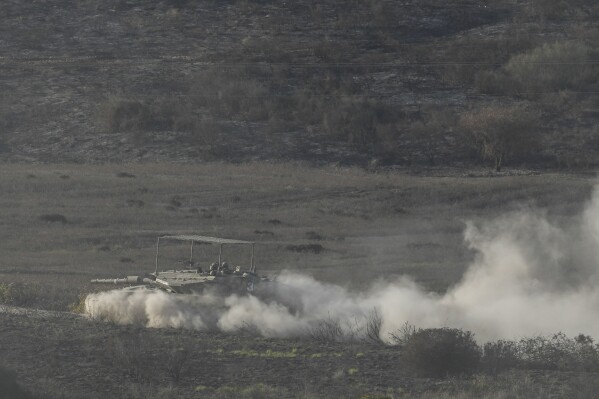 An Israeli tank manoeuvres in the Gaza Strip, as seen from southern Israel, Friday, Nov. 10, 2023. (AP Photo/Leo Correa)