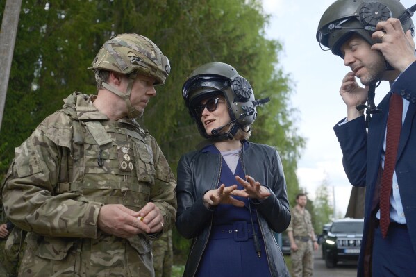 Estonian Prime Minister Kaja Kallas, center, speaks to Brig. Giles Harris, commander of British forces in Estonia, left, and Ross Allen, British ambassador to Estonia, at an undisclosed location in Estonia on Wednesday, May 15, 2024. Kallas was visiting the country's largest defense exercises. (AP Photo/Hendrik Osula)