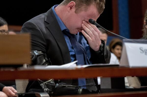 Former Marine Sgt. Tyler Vargas-Andrews, who was gravely injured, losing an arm and a leg in a suicide attack at Hamid Karzai International Airport in Kabul, becomes emotional as he recounts his story during a House Committee on Foreign Affairs hearing on the United States evacuation from Afghanistan on Capitol Hill in Washington, Wednesday, March 8, 2023. (AP Photo/Andrew Harnik)