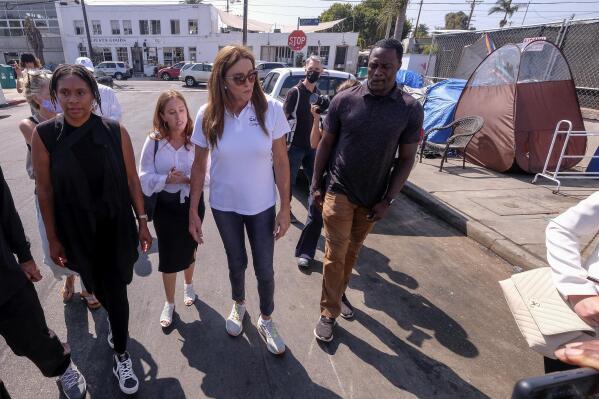 Caitlyn Jenner, center, a Republican candidate for California governor, walks down the street prior to a news conference in the Venice Beach section of Los Angeles, Thursday, Aug. 12, 2021. (AP Photo/Ringo H.W. Chiu)