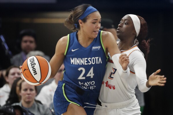 Minnesota Lynx forward Napheesa Collier (24) works past Phoenix Mercury guard Kahleah Copper (2) in the fourth quarter of a WNBA basketball game Saturday, June 22, 2024, in Minneapolis. (AP Photo/Bruce Kluckhohn)