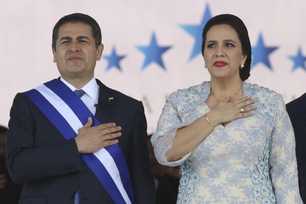FILE - Honduran President Juan Orlando Hernandez, left, stands with his wife Ana Garcia, during the presidential inauguration ceremony for his second term at the National Stadium in Tegucigalpa, Honduras, Jan. 27, 2018. The former first lady said Tuesday, March 12, 2024, just days after her husband’s U.S. drug trafficking conviction, that she plans to seek the country’s presidency in 2025. (AP Photo/Fernando Antonio, File)