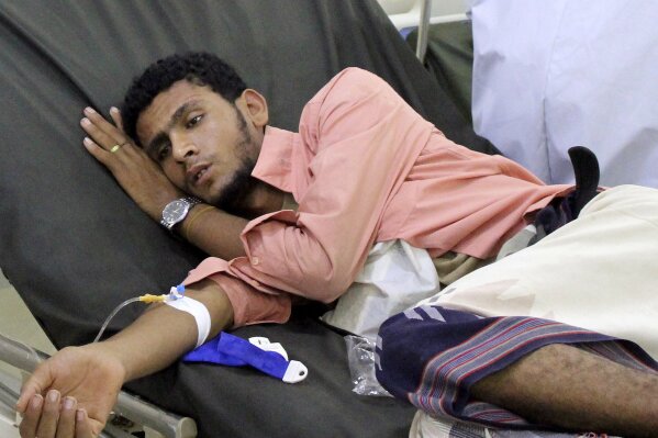 In this May 12, 2020 photo, a Yemeni man receives treatment as he lies on a bed at a hospital in Aden, Yemen. People have been dying by the dozens each day in southern Yemen's main city, Aden, many of them with breathing difficulties, say city officials. Blinded with little capacity to test, health workers fear the coronavirus is running out of control, feeding off a civil war that has completely broken down the country. (AP Photo/Wail al-Qubaty)