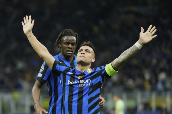 Inter Milan's Lautaro Martinez celebrates after scoring his side's opening goal during the Champions League semifinal second leg soccer match between Inter Milan and Barcelona at San Siro stadium in Milan , Italy, Tuesday, May 6, 2025. (AP Photo/Luca Bruno)